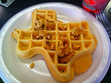 a texas shaped waffle on a styrofoam plate.